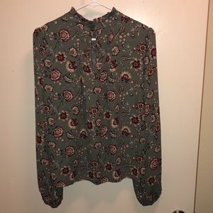 A floral and green long sleeved blouse